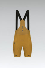 Gobik Matt Compact Men's Bibshorts in Turmeric yellow with black straps on studio background
