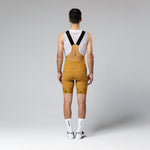 Gobik Matt Compact Men's Bibshorts in Turmeric yellow color, rear view showing suspender straps