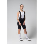 Woman wearing black Gobik Limited 6.0 bib shorts with white tank top
