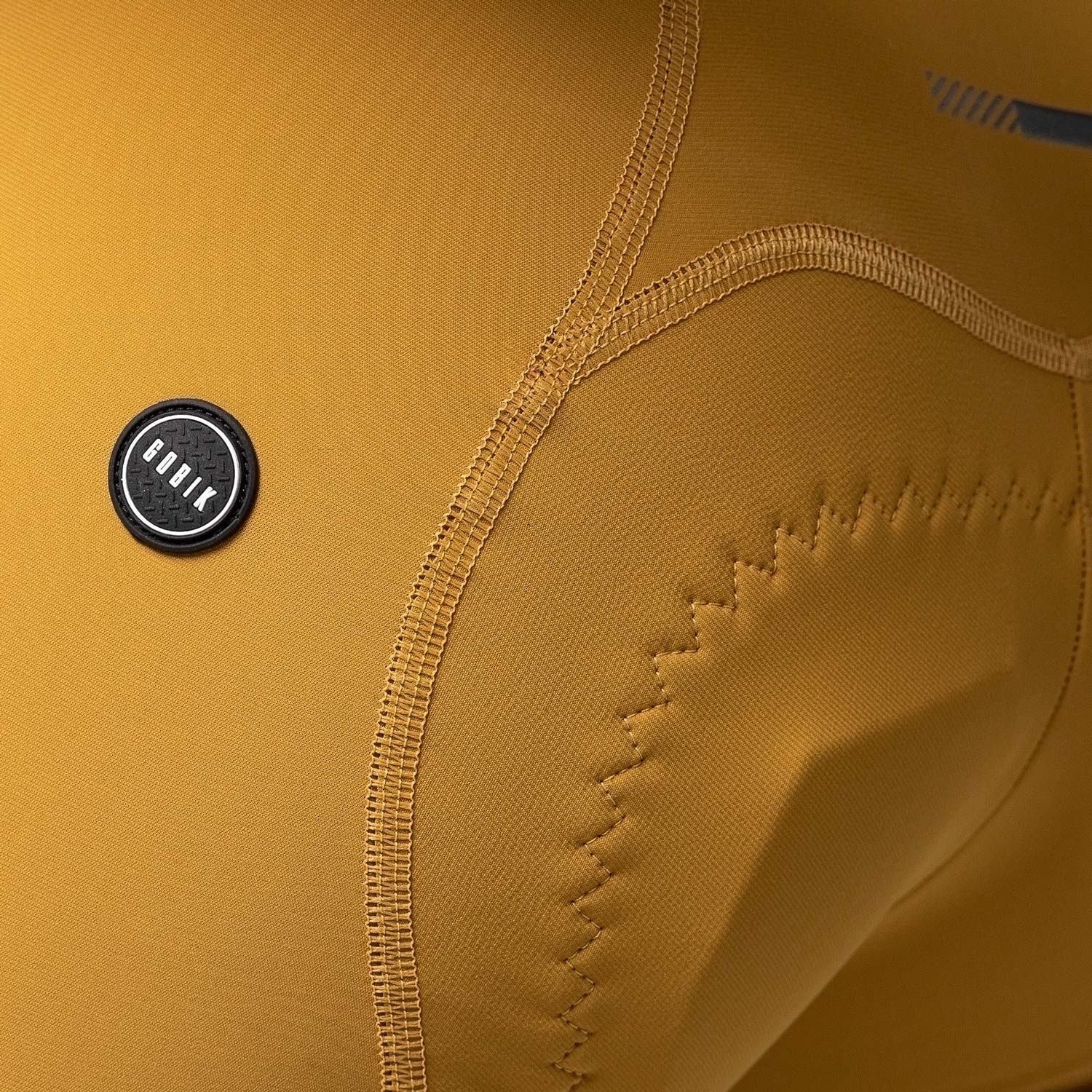 Gobik Matt Compact Men's Bibshort in turmeric showing design details and stitching