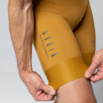 Gobik Matt Compact men's bibshorts in turmeric color showing leg gripper detail