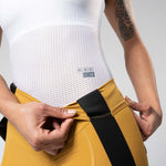 Gobik Matt Women's Bib Shorts in Turmeric showing waistband detail and fabric construction