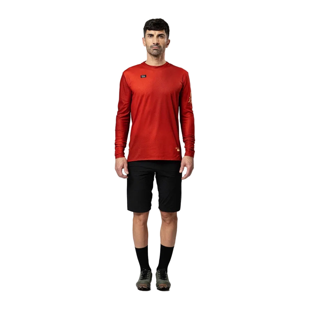 Man wearing red Gobik Terrain long sleeve cycling shirt with black shorts