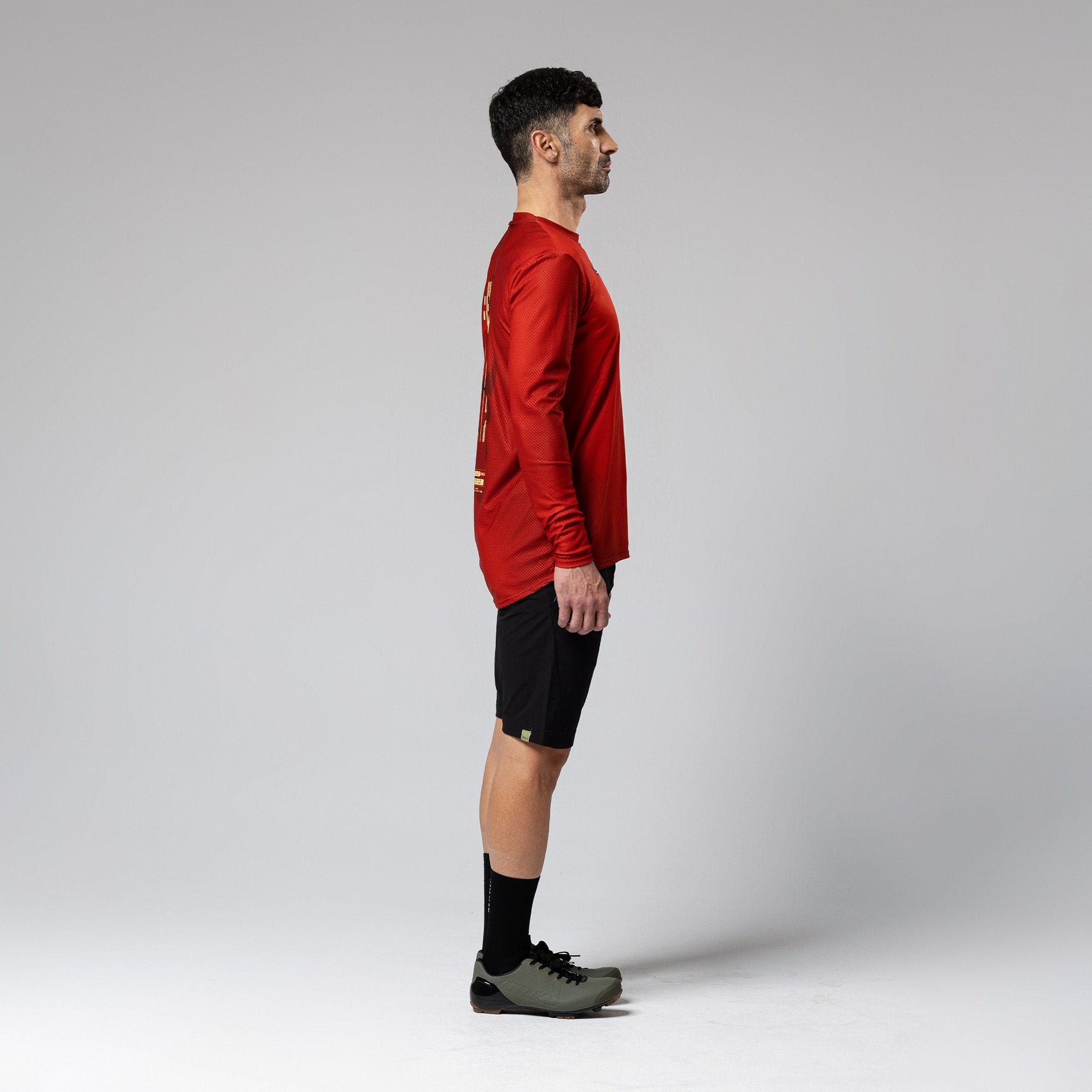 Man wearing red Gobik Terrain long sleeve cycling shirt with black shorts