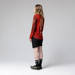 Woman wearing red Gobik Terrain long sleeve cycling shirt with black shorts