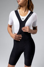 Woman wearing black Gobik Ultralite bib shorts with white mesh top