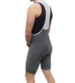 Man wearing grey Legg Plus bibshort with white straps, shown from behind