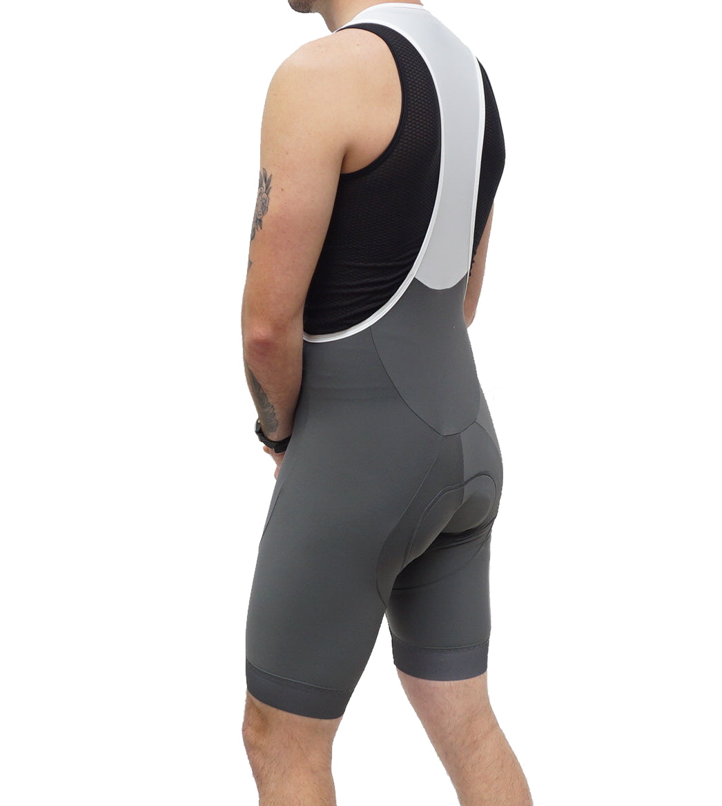 Man wearing grey Legg Plus bibshort with white straps, shown from behind
