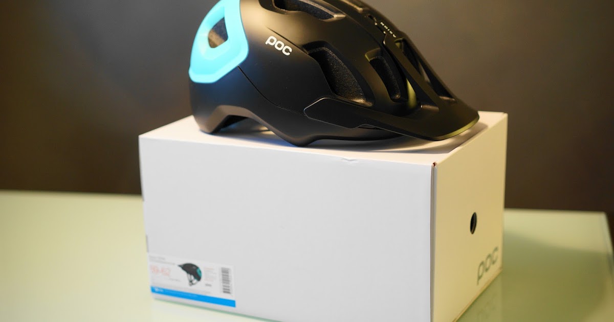 POC Axion Spin helmet in Kalkopyrit Blue Matt colorway on white box