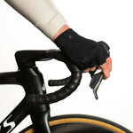 Black fingerless cycling gloves worn on handlebars in professional studio setting