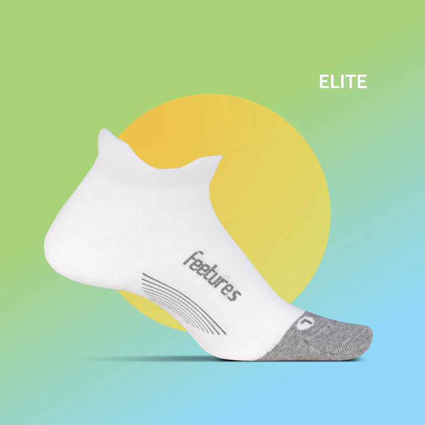 White Feetures Elite low-cut running sock with gray accents on colorful gradient background