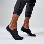Black Feetures Elite Light Cushion Invisible no-show socks on model's feet