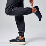 Feetures Elite Light Cushion Invisible black no-show socks worn by male model in running gear