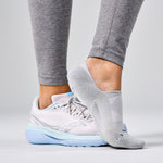 Gray Feetures Elite Light Cushion Invisible no-show socks worn with running shoes