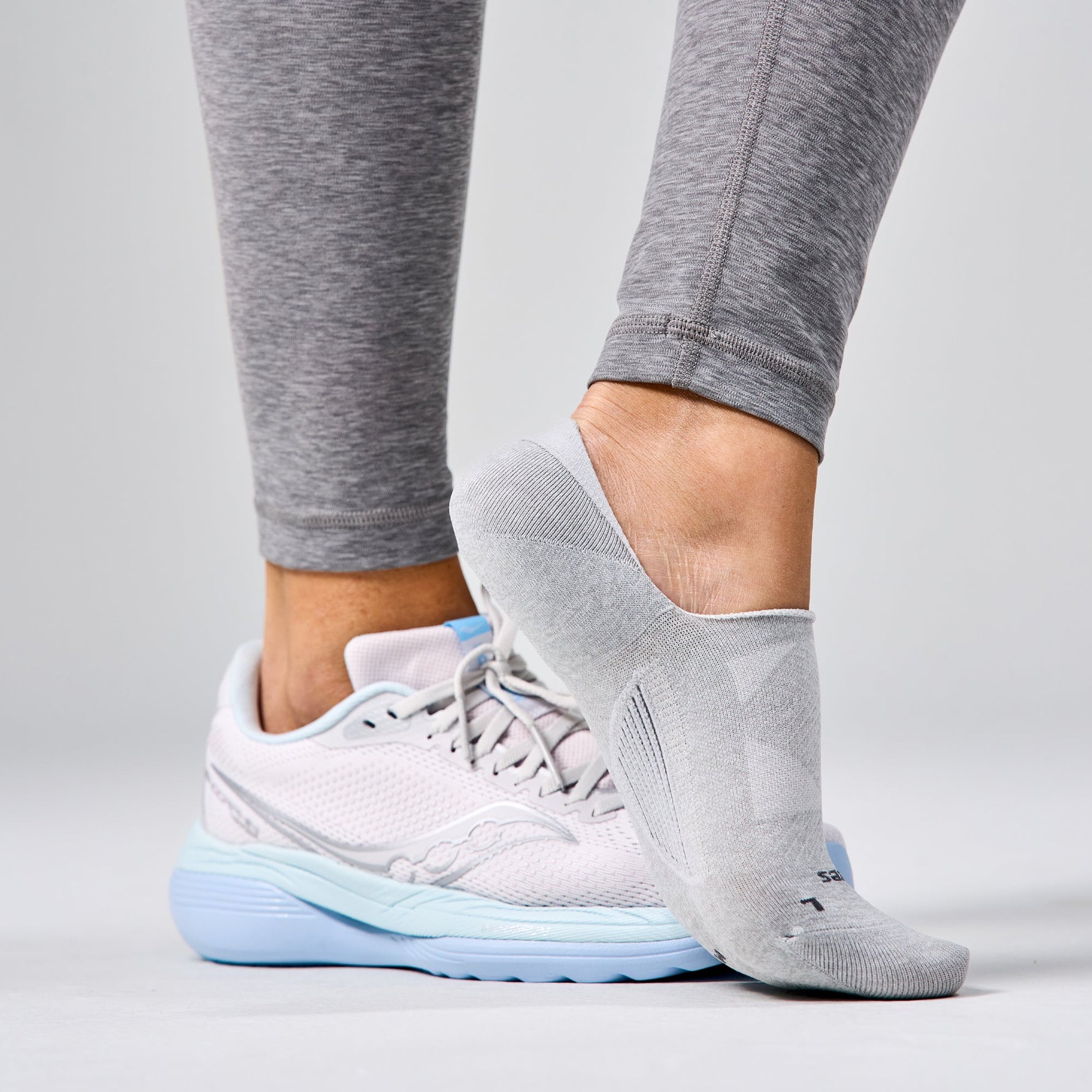 Gray Feetures Elite Light Cushion Invisible no-show socks worn with running shoes