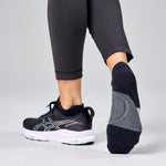 Feetures Elite Light Cushion Tab socks in navy and grey worn with running shoes