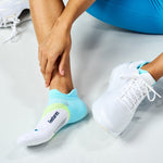 Person wearing Feetures Elite Light Cushion Tab socks with blue gradient pattern