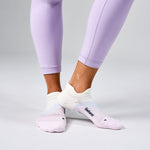 Feetures Elite Light Cushion Tab socks in white and pink gradient worn with purple leggings