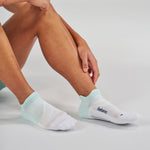Feetures Elite Light Cushion Tab socks in Stone Ivy worn by model on clean background