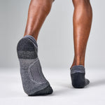 Feetures Elite Max Cushion Tab socks in grey worn on feet walking