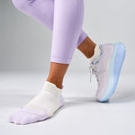 White Feetures Elite Max Cushion Tab socks worn with purple leggings and sneakers