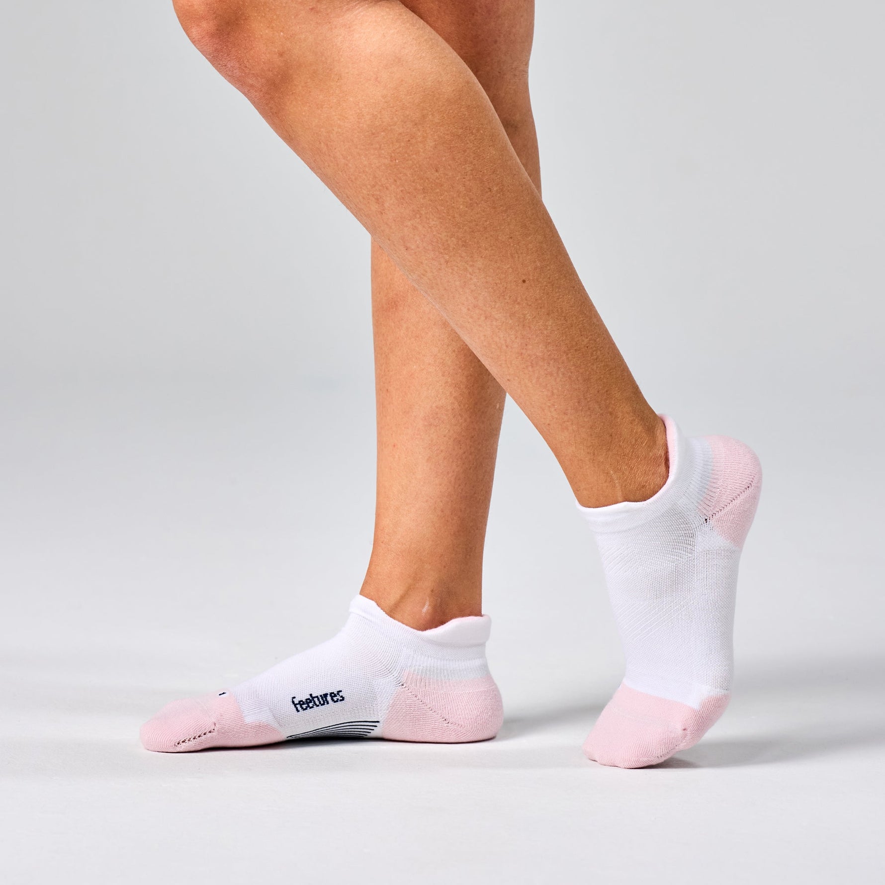 Feetures Elite Max Cushion Tab ankle socks in white with pink heel and toe