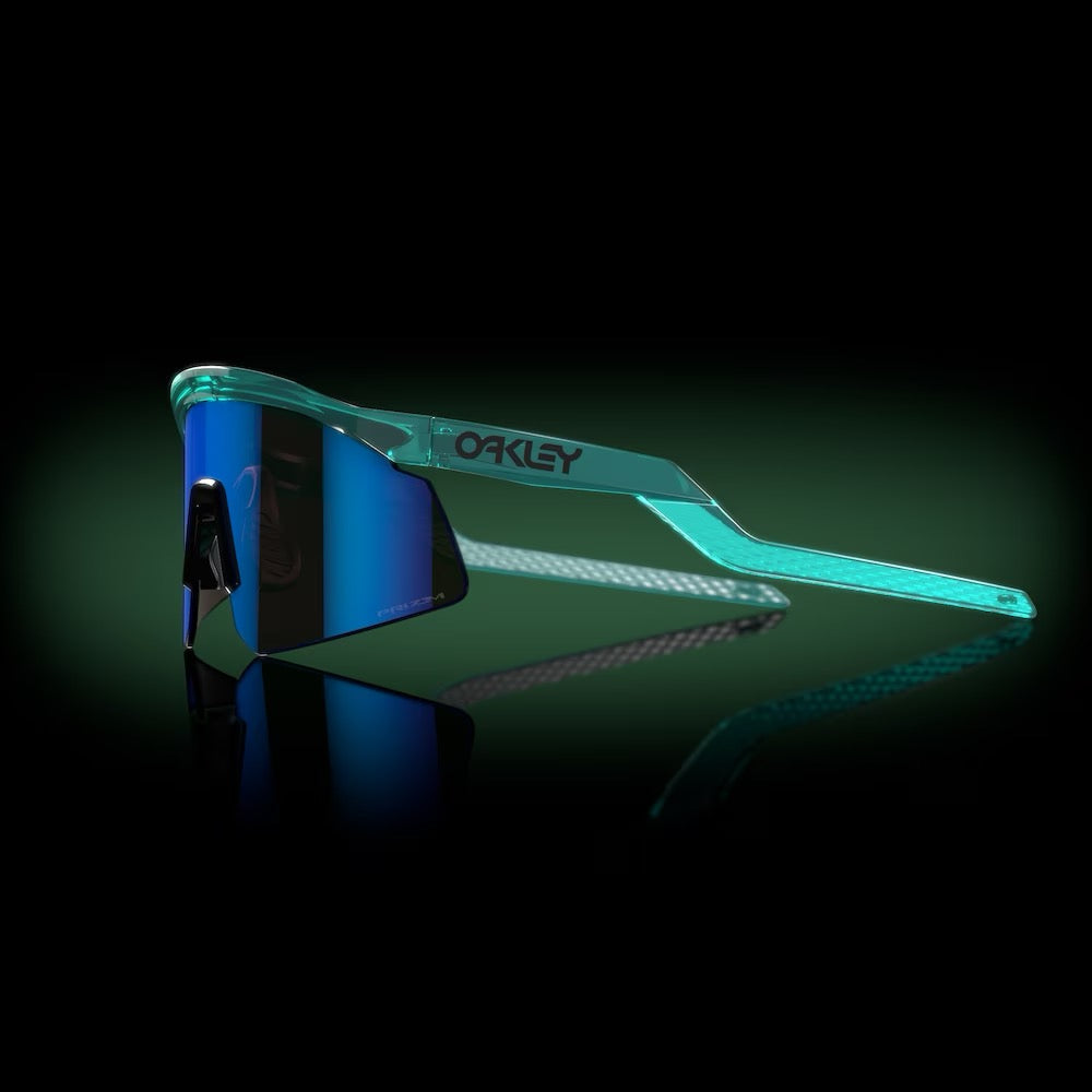 Oakley Hydra sunglasses with translucent teal frame and blue mirrored lenses