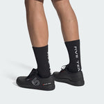 Five Ten Freerider Pro MTB shoes in black worn on feet with black socks