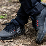 Five Ten Freerider Pro MTB shoes in black with white accents on outdoor terrain