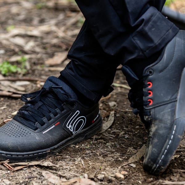 Five Ten Freerider Pro MTB shoes in black with white accents on outdoor terrain