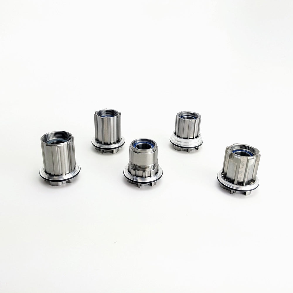 Five White Industries CLD XDR compatible freehub bodies in silver chrome finish
