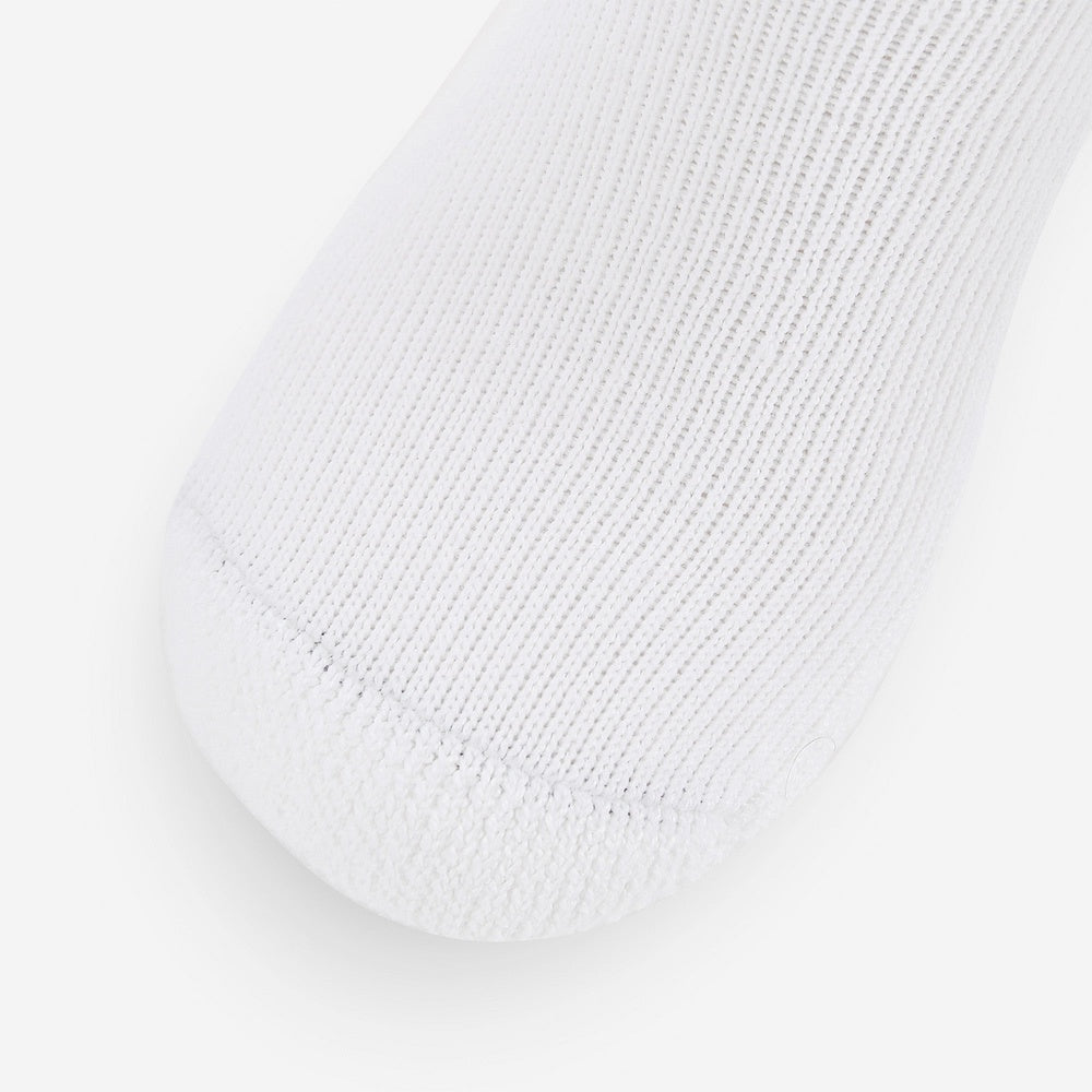 Close-up of white Thorlos Golf Moderate Cushion Crew Sock toe area showing cushioning detail