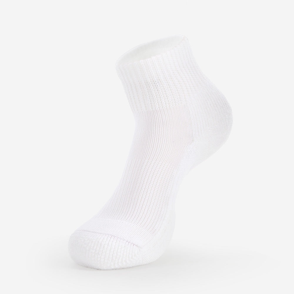 Thorlos white ankle golf sock with ribbed cuff and cushioned sole displayed on foot form