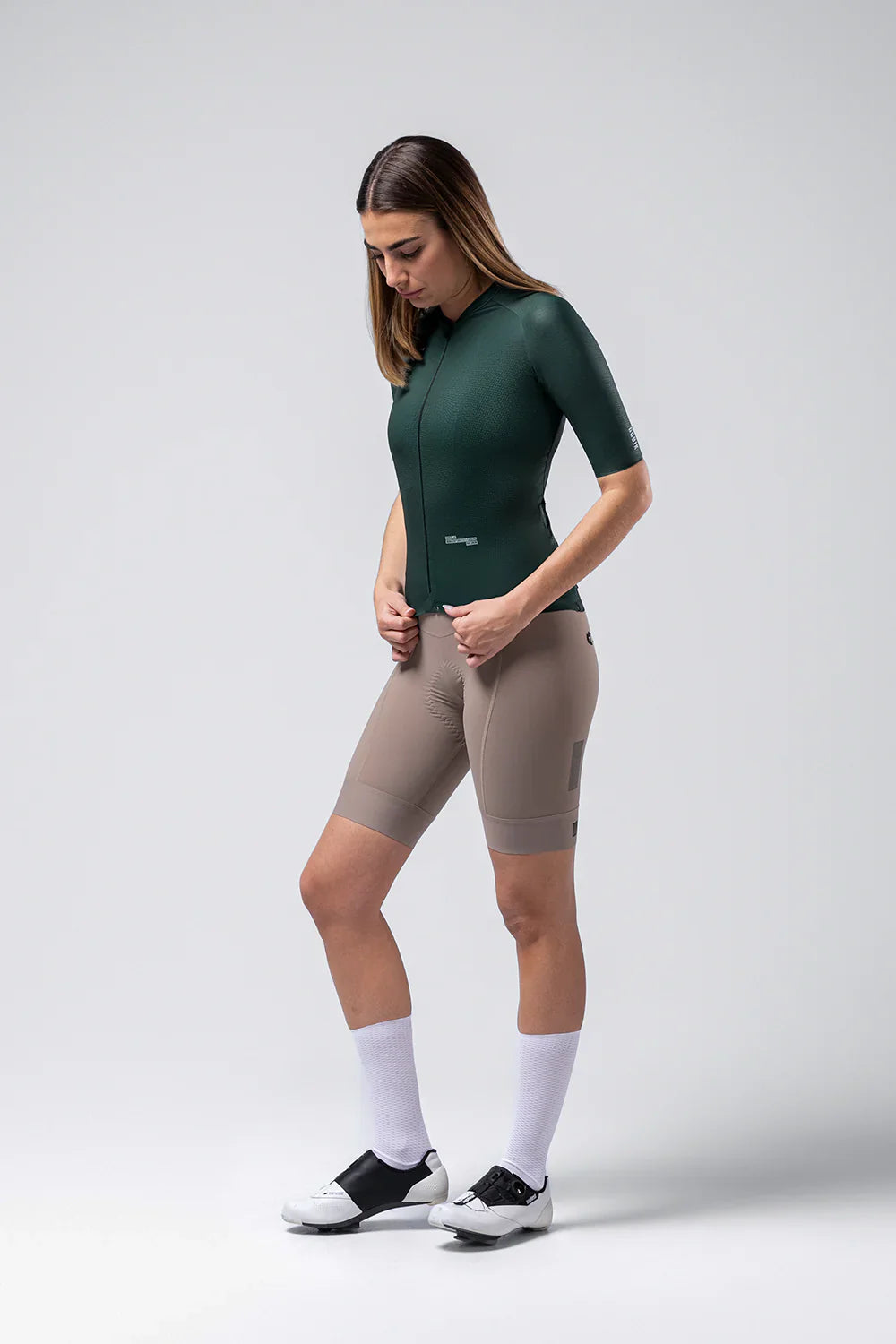 Woman wearing Gobik Infinity short sleeve cycling jersey in bunker green with cycling shorts