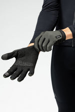 Person wearing Gobik Lynx cycling gloves in army green and black colors