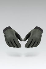 Pair of olive green Gobik Lynx cycling gloves with black fingertips on gray background
