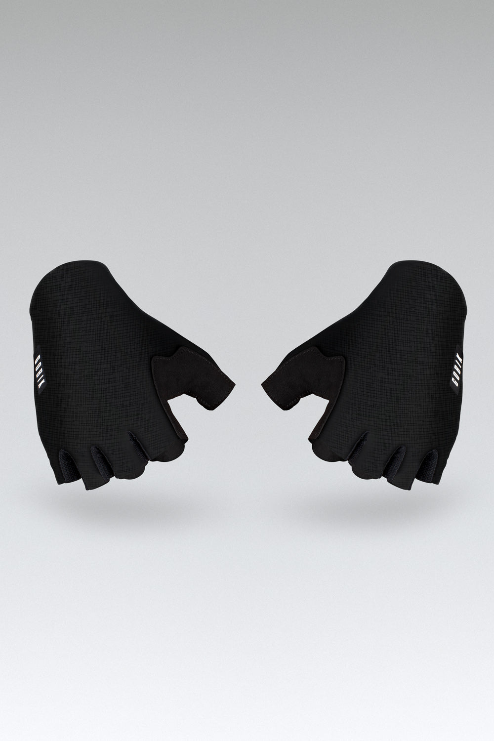 Black Gobik Mamba 2.0 cycling gloves with fingerless design on gray background