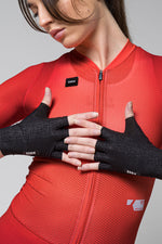 Woman wearing black Gobik fingerless cycling gloves with red cycling jersey