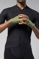 GOBIK olive green cycling gloves worn by cyclist in black jersey