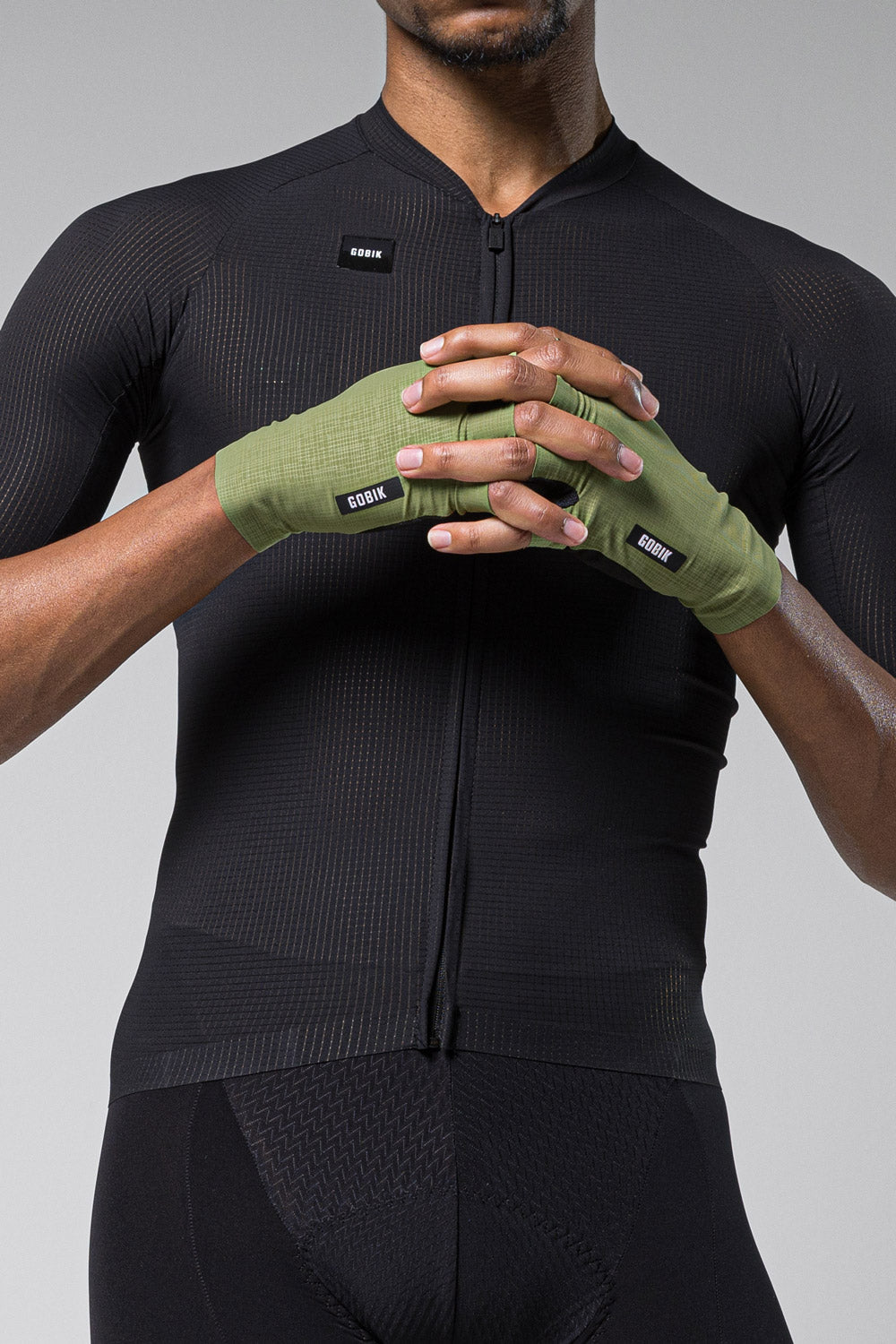 GOBIK olive green cycling gloves worn by cyclist in black jersey