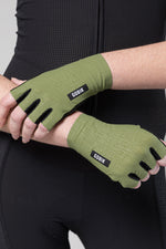 Gobik olive green cycling gloves with black branding worn on hands