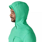 Man wearing bright green Patagonia hooded sun protection shirt, side profile view