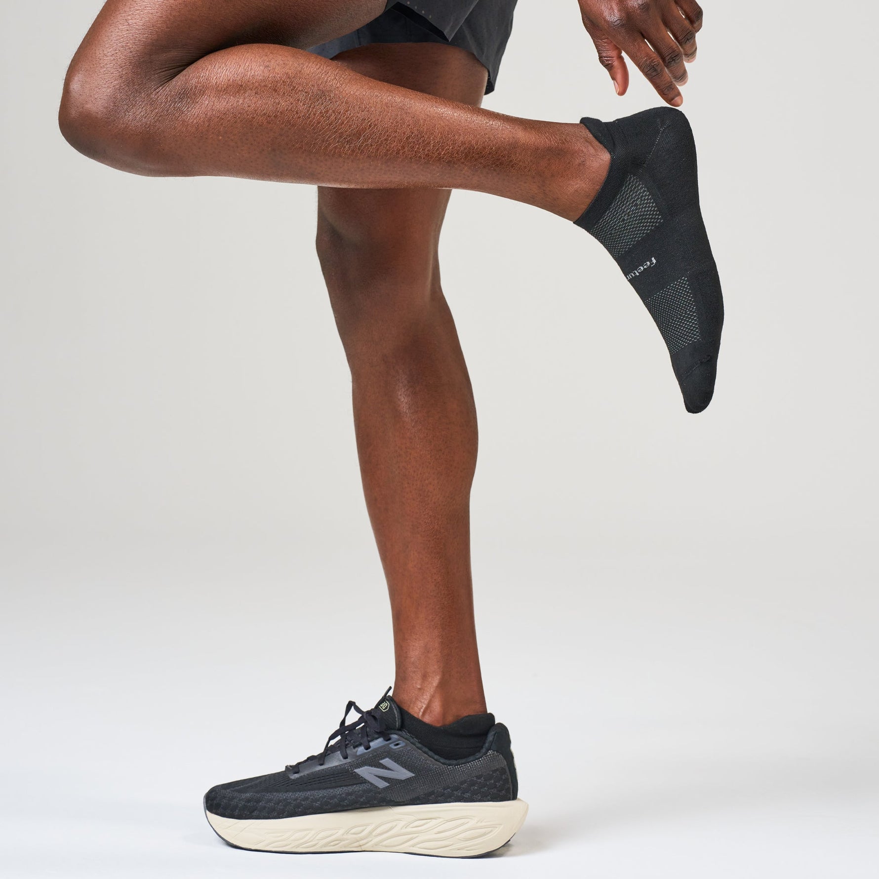Black Feetures High Performance Max Cushion Tab socks worn by runner
