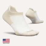 Feetures white performance tab socks with beige accents on clean background