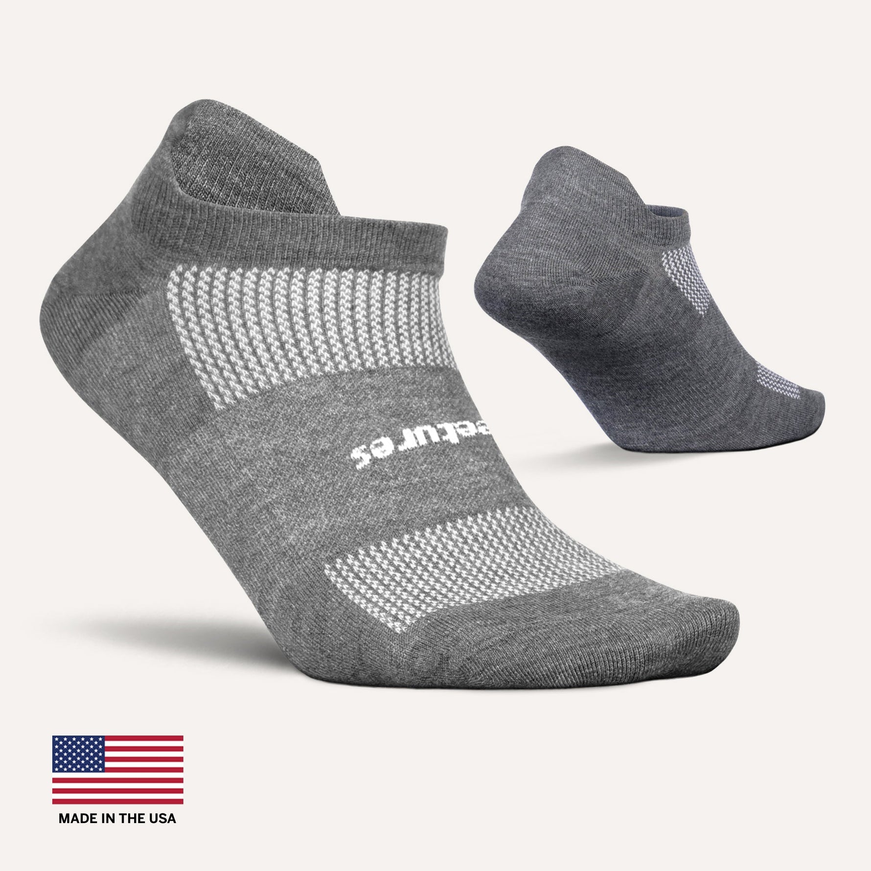Feetures grey athletic no-show socks with white mesh ventilation panels and branding