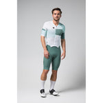 Male cyclist wearing Gobik Brooklyn Aerosuit in white and green gradient colorway