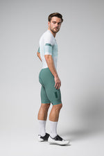 Male model wearing Gobik Brooklyn Aerosuit in white and sage green colorway