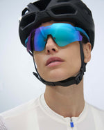 KOO Nebula cycling sunglasses in teal matt frame with dark turquoise mirror lens worn with helmet