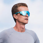 KOO Nova sunglasses in Acqua Matt turquoise frame with blue mirrored lenses worn by athlete