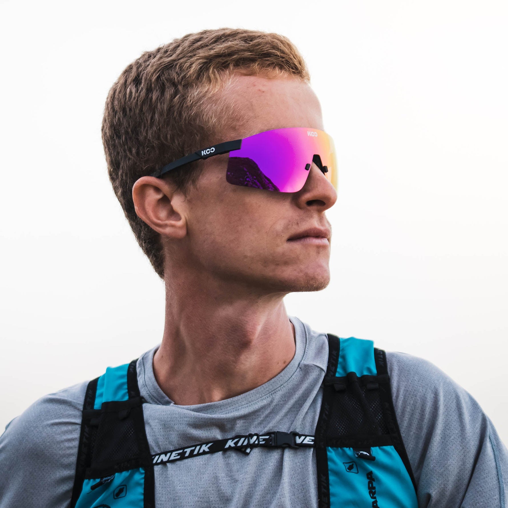 KOO Nova sunglasses in black matte frame with purple-pink mirrored lenses worn by athlete